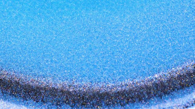 Mixing fragments of alcohol ink with blue and dark colors on surface