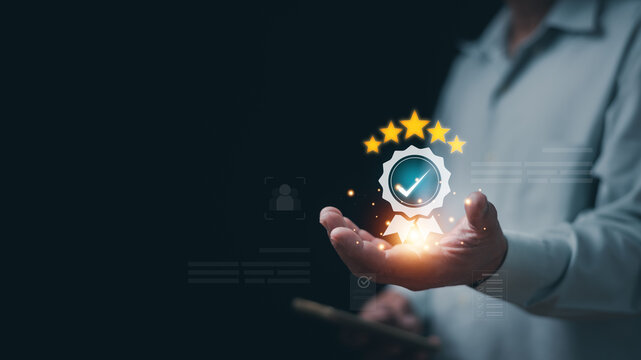 Quality assurance concept. Businessman holding certified check mark and five star rating in hand. Representing customer satisfaction, service excellence, trust, approval and performance evaluation.