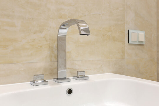 Chrome faucet in condominium bathroom