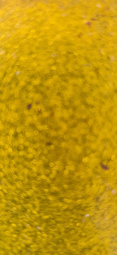 Abstract golden-yellow textured background with soft natural patterns and subtle spots.