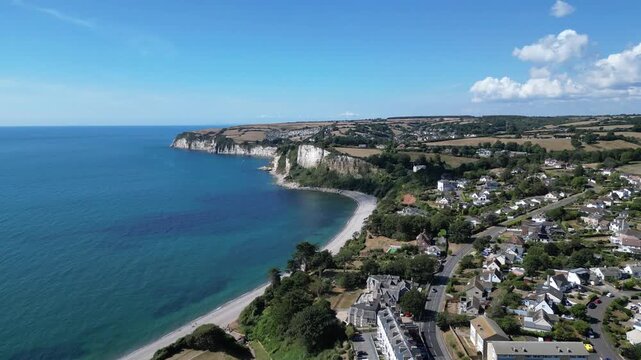 Seaton, Devon, England: DRONE VIEWS: The drone flies over the town of Seaton heading towards the beach and chalk cliffs which form part of the Jurassic Coast UNESCO World Heritage Site coastline.