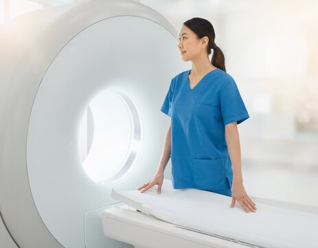 Female radiographer standing beside an MRI scanner in a bright imaging room