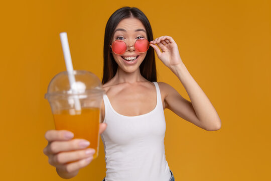 Excited woman surprised by refreshing summer drink