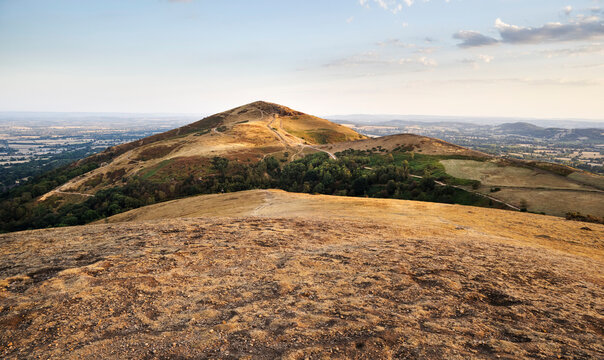 View of sun baked Worcestershire Beacon at sunset,atop the Malvern Hills,Worcestershire,England,UK.