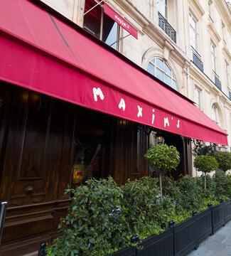 PARIS, FRANCE - SEPTEMBER 1, 2026 - Maxim's de Paris restaurant displaying its iconic red awning and historic Parisian architecture