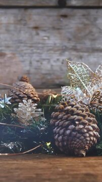 Composition of light over christmas decorations with pine cones