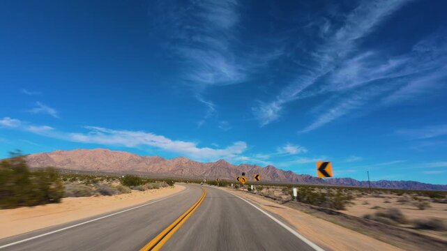 Mojave Desert POV Drive Around Curve Through Rocky Landscape