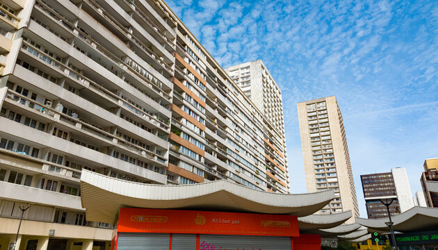 PARIS, FRANCE - SEPTEMBER 1, 2026 - Les Olympiades buildings and urban shopping structures standing under a blue sky