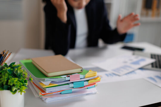 Stressed business professional facing overwhelming workload, receiving too much paperwork, dealing with administrative burden, and experiencing burnout in a busy office environment