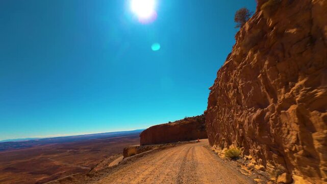 Moki Dugway POV Drive Under Bright Sun on Cliffside Road in Utah