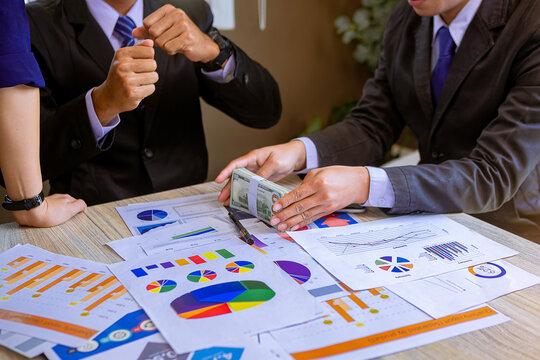 Businessman paid Dollars money banknotes and making decision for business investment while meeting with business partners Selected focus