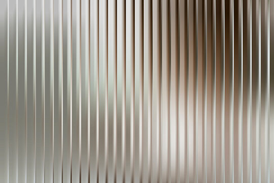 Vertical metallic ribbed texture with soft gradient light reflections