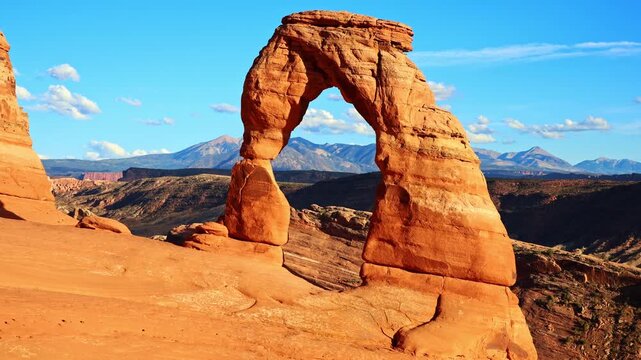 Golden sunset light glows over the iconic Delicate Arch in this close up view at Arches National Park