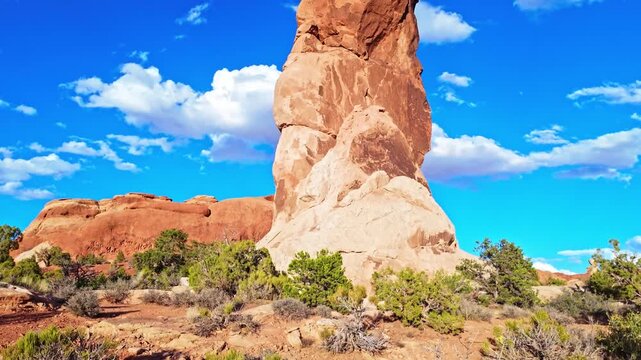 Golden sunset light glows over Double O Arch and the Devils Garden landscape in Arches National Park