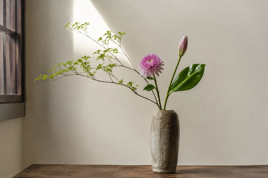 Ikebana flower arrangement in tall ceramic vase, minimalist home decor and serenity concept