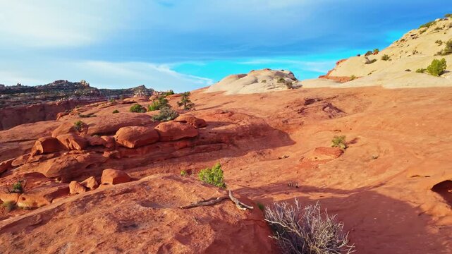 Vast red rock walls and sandstone cliffs tower over Grand Wash canyon along the Cassidy Arch trail in Capitol Reef National Park Utah