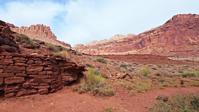 Historic pioneer lime kiln built of stacked sandstone and river rocks sits below desert cliffs along Sulphur Creek in Utah