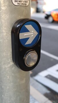 close-up of a pedestrian crossing button in a city