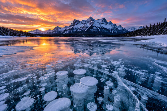 Frozen Methane Bubbles Trapped Beneath Clear Lake Ice at Winter Sunset
