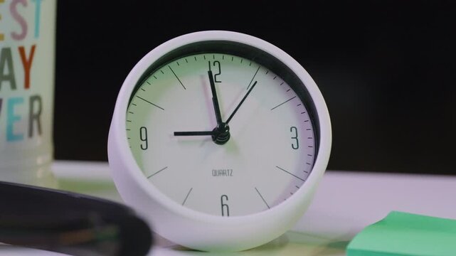 A small desk clock ticking along for almost a minute in real time