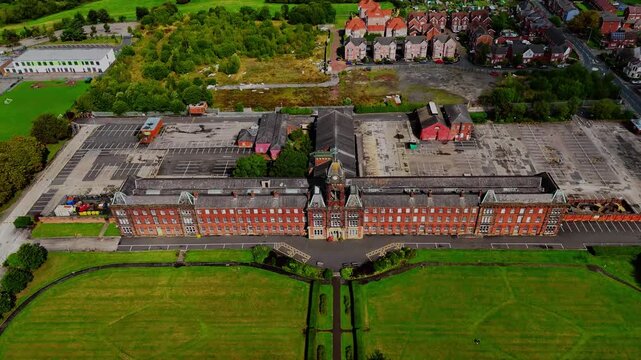 Aerial pull back shot of a historic red brick building in Fulwood, Preston