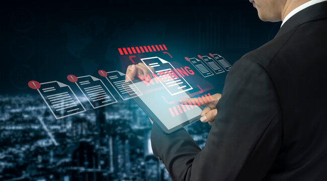A businessman interacts with a digital tablet displaying holographic documents in a modern cityscape, illustrating innovation in data management and technology. Gantry