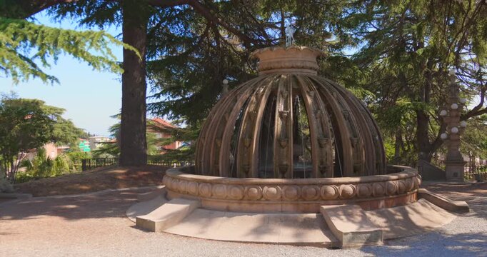 Dome-shaped stone fountain in shaded garden at Villa Grock, Italian Riviera landmark
