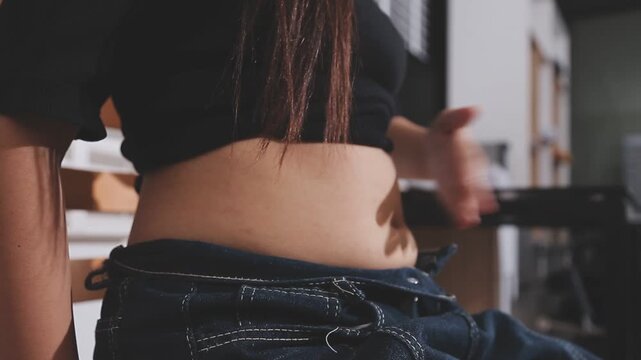 Women body fat belly. Obese woman hand holding excessive belly fat. diet lifestyle concept to reduce belly and shape up healthy stomach muscle.