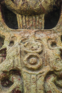 Ancient sculpted gaze and lower section details of ceremonial beard on Maya Stela B of 18 Rabbit 