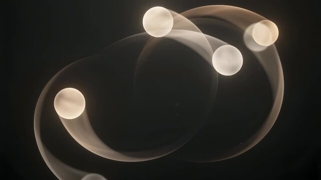 Abstract image of glowing spheres in motion with curved light trails on a dark background