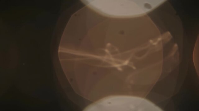 Abstract Ethereal Lens Flare with Soft Golden Light Leaks on a Dark Cinematic Background