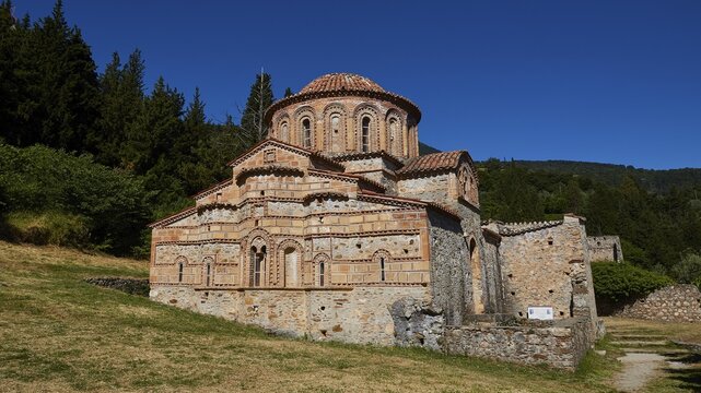Remains of the great monastery of Brontochion, Church of Agioi Theodoroi, Byzantine church with bricks in the middle of a green landscape under a clear blue sky, Mystras, Mistra, UNESCO World Heritage Site, Medieval Byzantine ruined city, north-west of Sparta, foothills of the Tyagetos Mountains, Peloponnese, peninsula, Greece