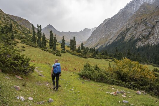 Hiker in the mountain valley, Chong Kyzyl Suu Valley, Terskey Ala Too, Tien-Shan Mountains, Kyrgyzstan