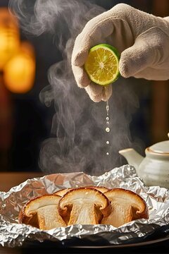 Hand squeezing lime juice onto grilled matsutake mushrooms on foil, steaming hot japanese food, generative AI