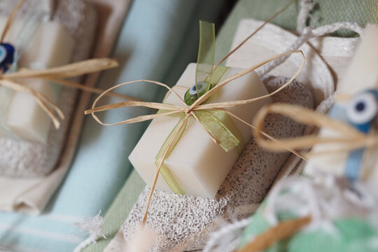 Handmade soaps displayed on soft fabric backdrop