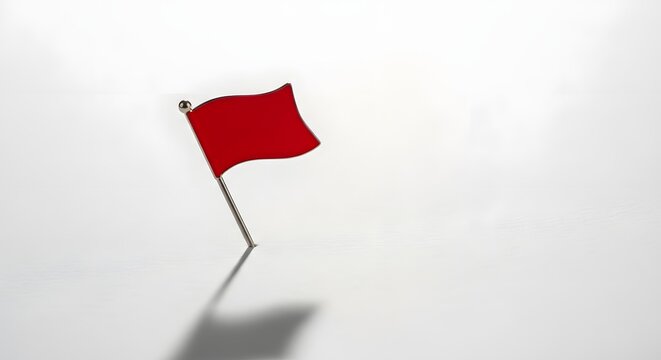 A small red flag pin on a clean white background