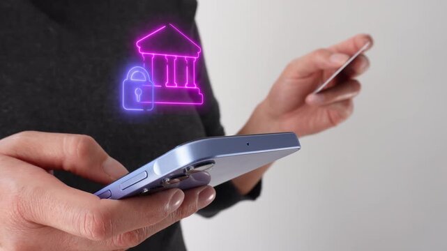 Online banking. Businesswoman holding a bank card and a smartphone displaying a virtual bank icon with a padlock.