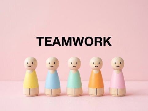 Five colorful wooden figures lined under teamwork text suitable for HR presentations symbolizing unity collaboration and workplace diversity
