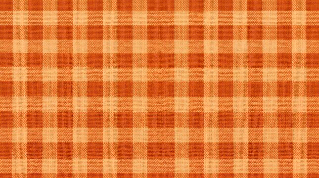 Autumn picnic blanket pattern creates warm textured background. Cosy vintage plaid fabric pattern. abstract chequered texture check, gingham tablecloth, fall
