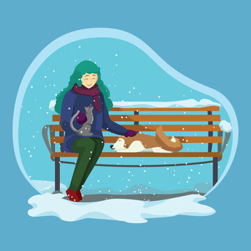 A smiling woman with teal hair sits on a snow-covered wooden park bench, holding a gray cat and petting a brown dog in winter.