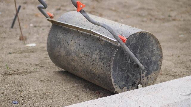 Rolling a dirt compactor on a construction site