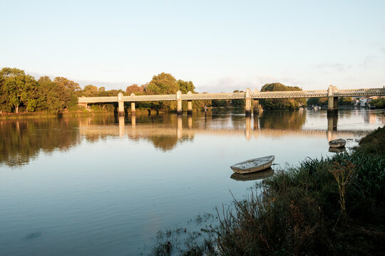 River thames flowing past kew railway bridge and moored boats