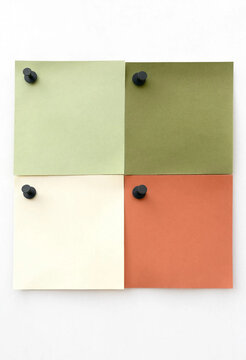 Four colorful sticky notes pinned on a white background for office organization and planning.