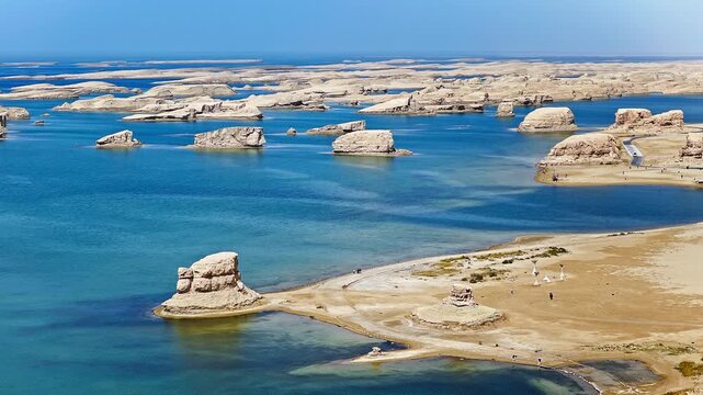 Aerial view of water yardang landforms surrounded by a turquoise lake in the Qaidam Basin, Qinghai, China
