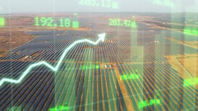 Aerial view over a vast solar power farm with rows of photovoltaic panels across dry terrain, combined with a glowing upward financial chart and market data overlay representing renewable energy