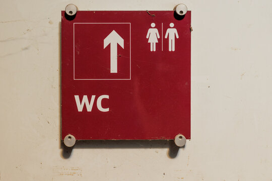 WC restroom direction sign indicating male and female facilities