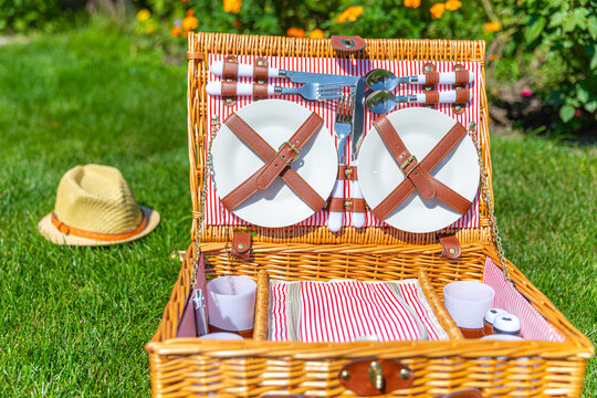 Picnic basket on green sunny lawn in the park