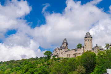 Fototapeta premium Historic Hilltop Castle Above Wooded Hillside