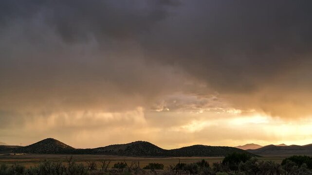Sunset timelapse looking over the landscape layers in Utah as a light storms roll through the sky.