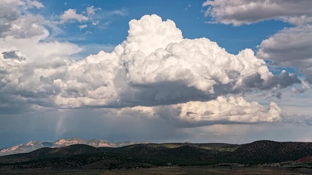Timelapse of a cumulonimbus cloud as it builds and storms roll in the background over Utah.